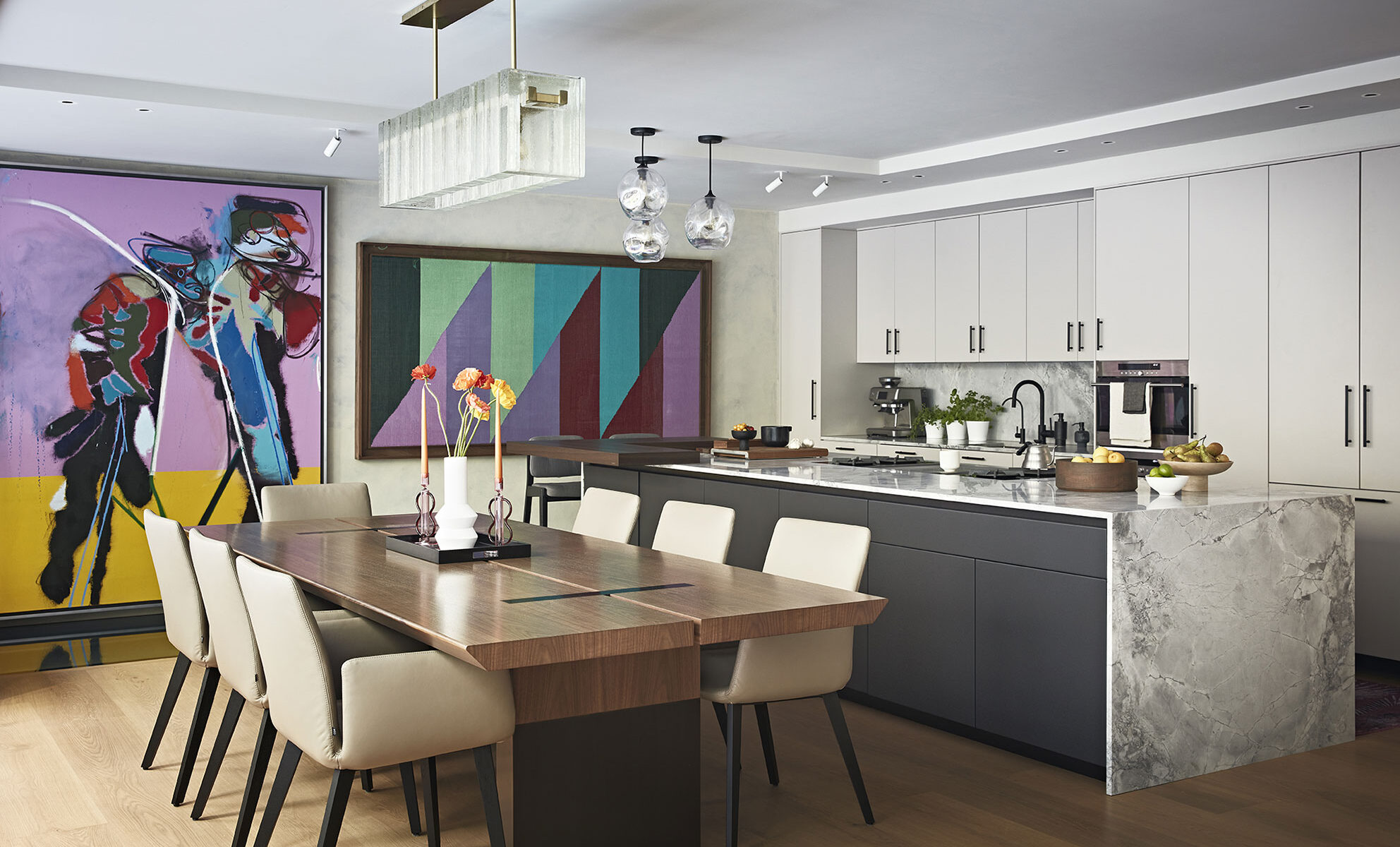 Luxury kitchen and dining room interior design in Notting Hill West London with a marble kitchen counter and colourful artworks on the wall