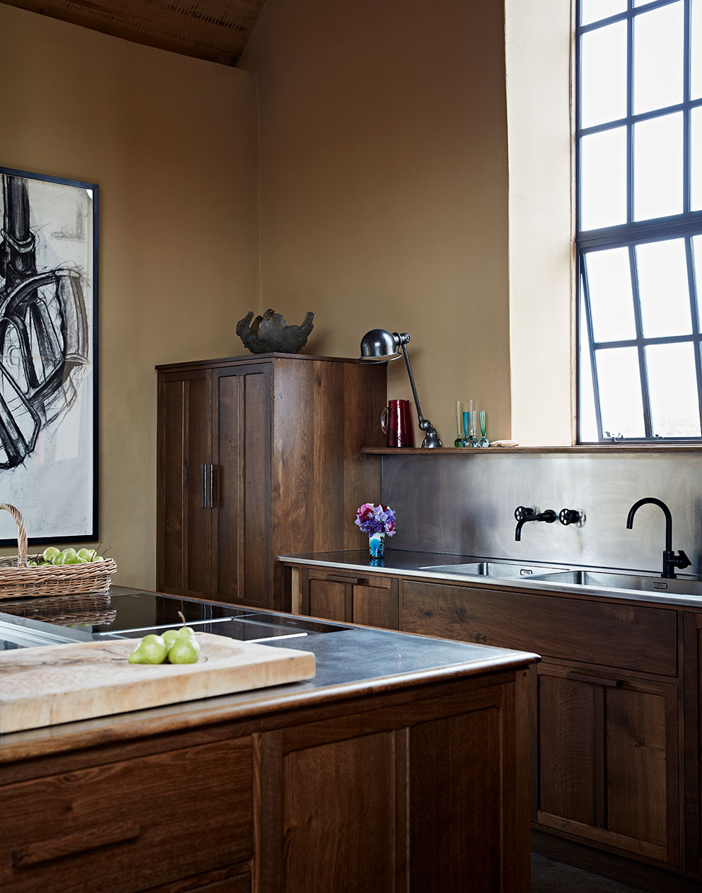 Close-up of the bespoke wooden kitchen in this rural home where the outbuildings have been converted to luxury living spaces by Godrich Interiors.